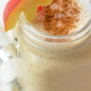 Green juice in a jar in front of a Vitamix A3500