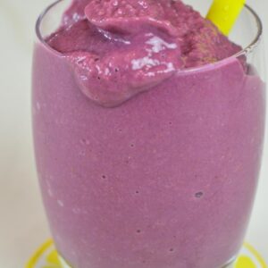 Green juice in a jar in front of a Vitamix A3500