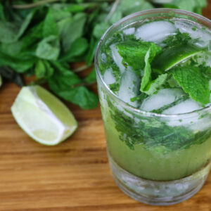 Green juice in a jar in front of a Vitamix A3500