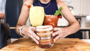 Holding three mocktails.