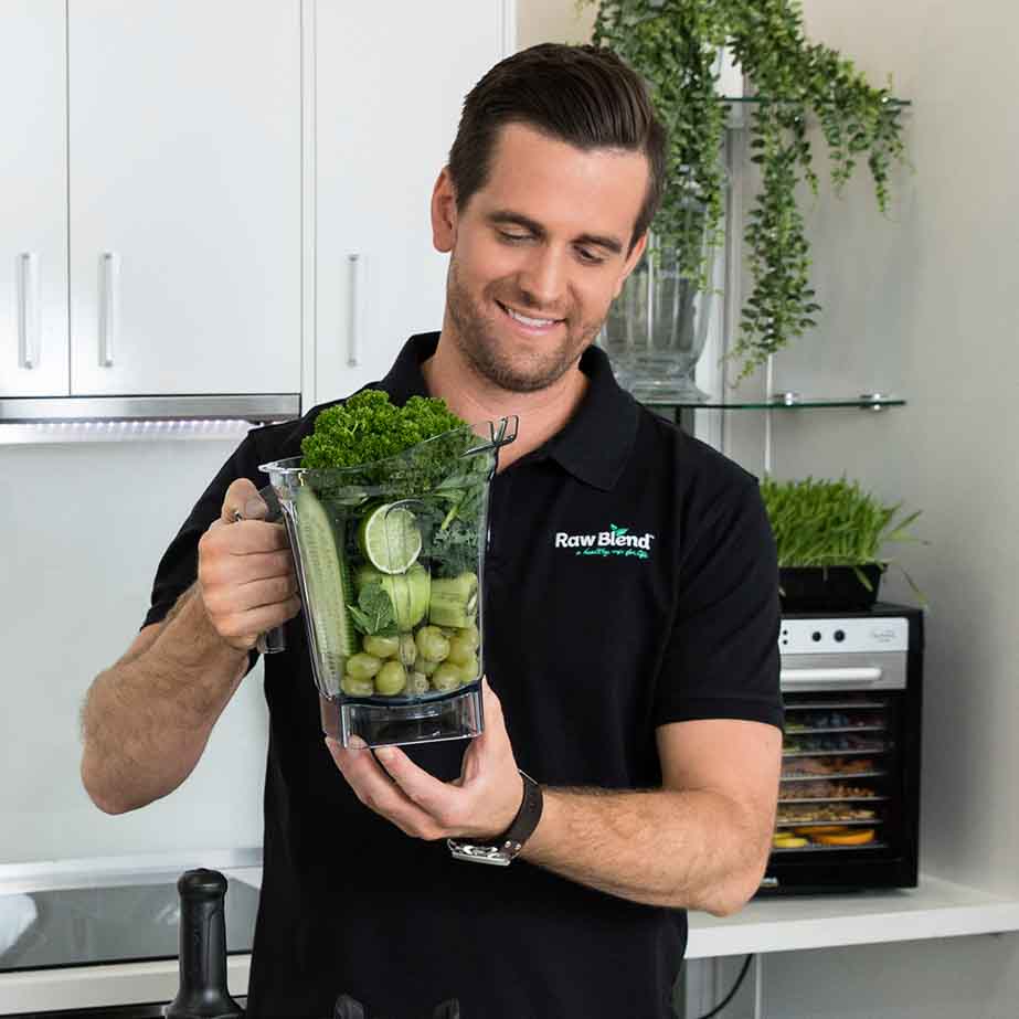 Tommy Nicholas of Raw Blend Australia with smoothie container of green juice ingredients.
