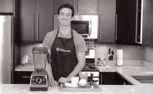 Black and white image of Lenny Gale circa 2014 demonstrating Vitamix blenders. 