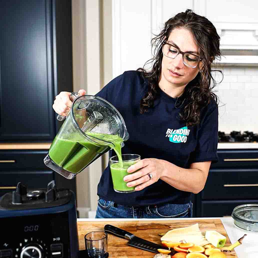 Shalva Gale of Blending For Good making green juice in a blender.